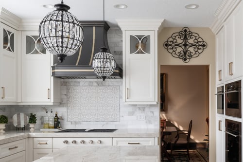 Elegant kitchen lighting over marble island in custom home by Conner Construction Company in Highland, UT