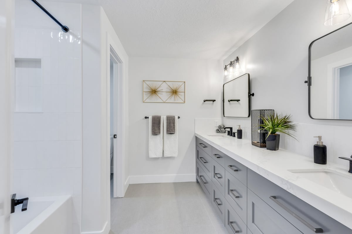 Contemporary bathroom with dual sinks and black fixtures in a custom home by Conner Construction Company in Eagle Mountain UT