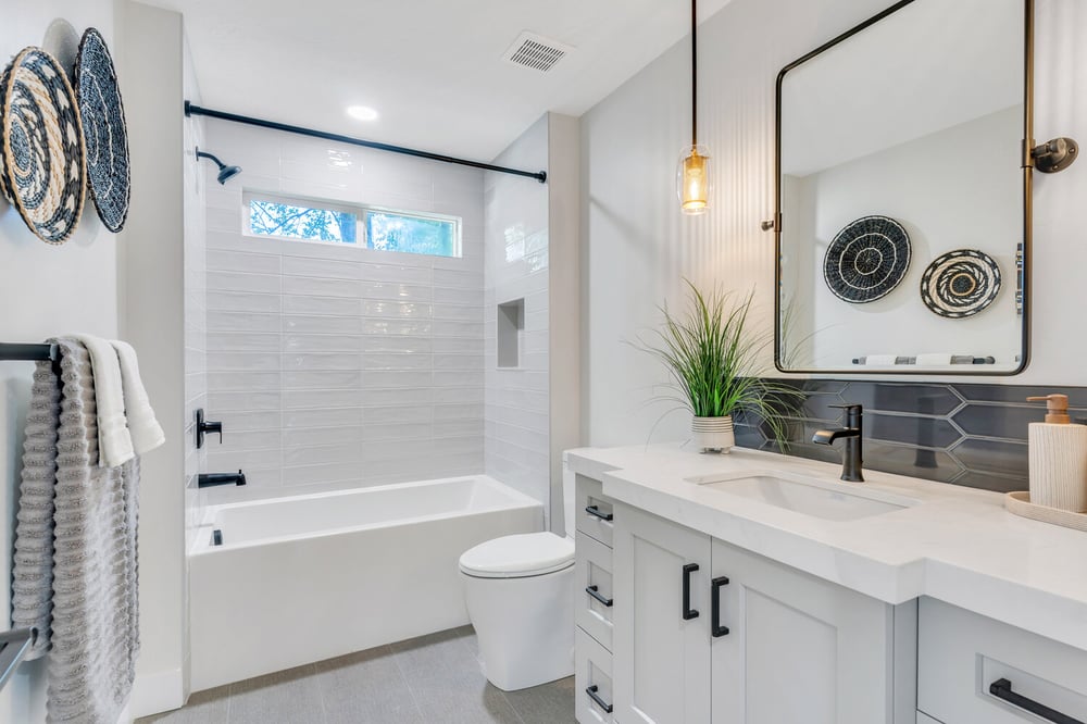 Custom bathroom remodel by Conner Construction Company in Utah County, UT featuring white tile shower and modern vanity