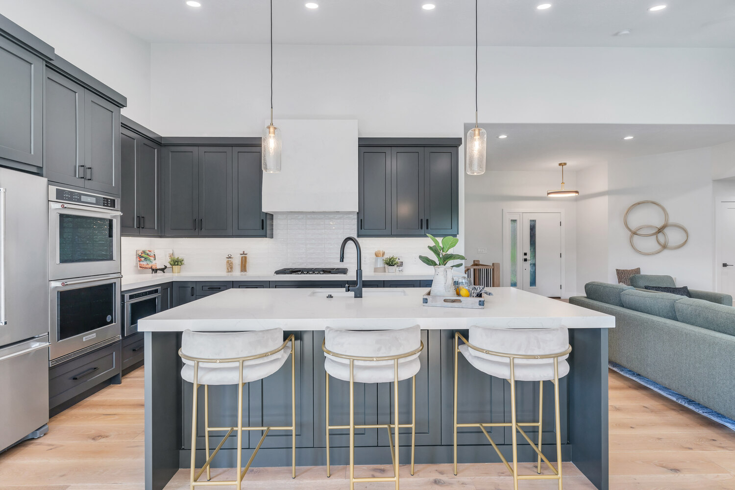 Modern kitchen with dark cabinets and pendant lighting in a custom home by Conner Construction Company in Pleasant Grove, UT