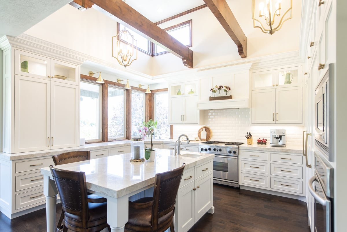 Classic kitchen design with dark hardwood floors and creamy white cabinets by Conner Construction Company in Utah County, UT