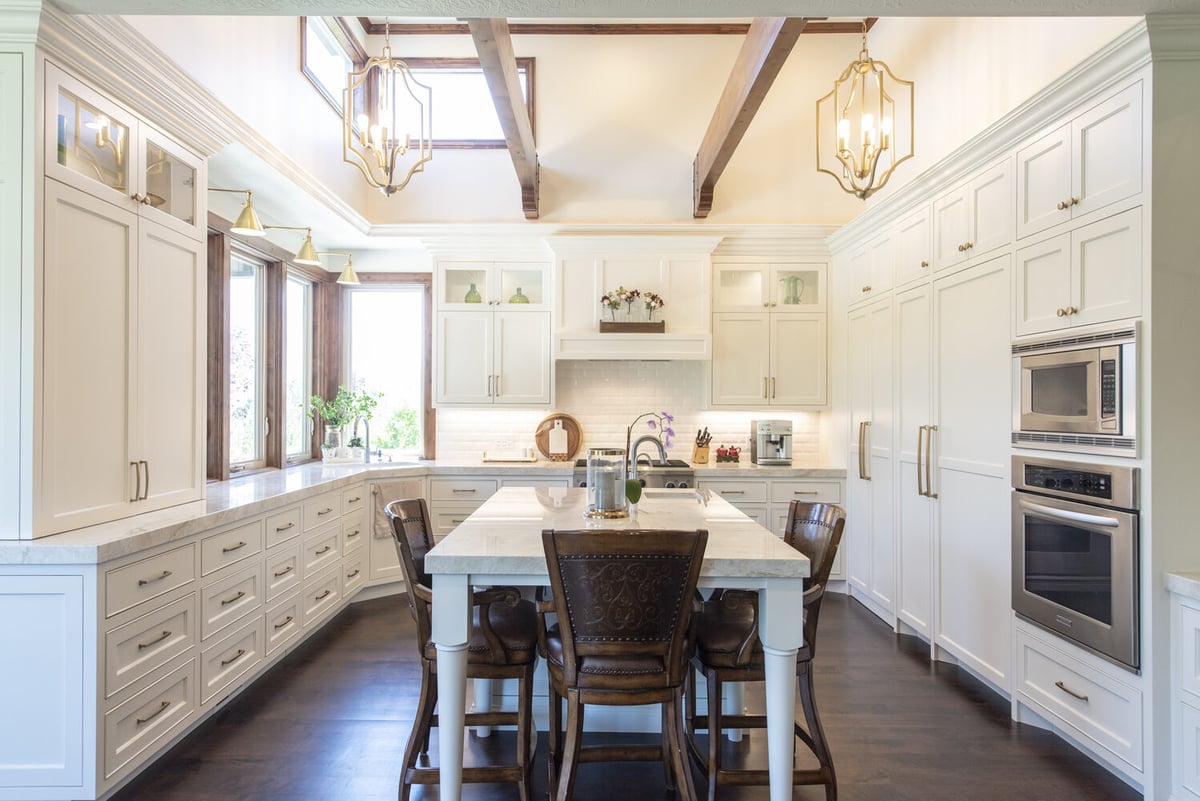 Luxurious custom kitchen with white cabinetry and exposed beams by Conner Construction Company in Highland, UT