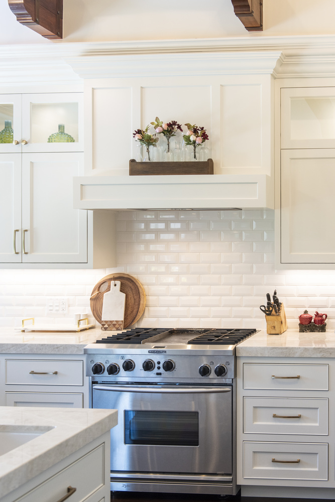 Stainless steel oven surrounded by white custom cabinetry by Conner Construction Company in Eagle Mountain, UT