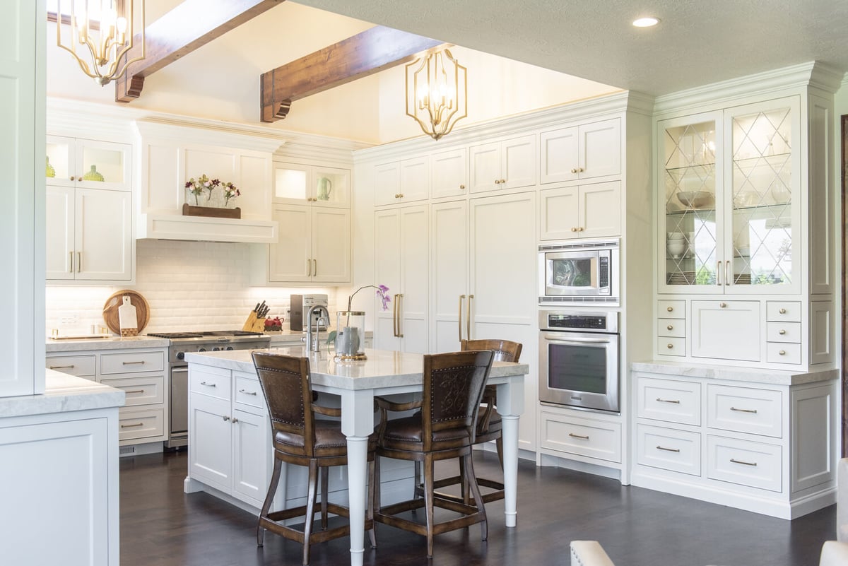 Timeless kitchen remodel featuring glass display cabinets and warm wood accents by Conner Construction Company in Orem, UT