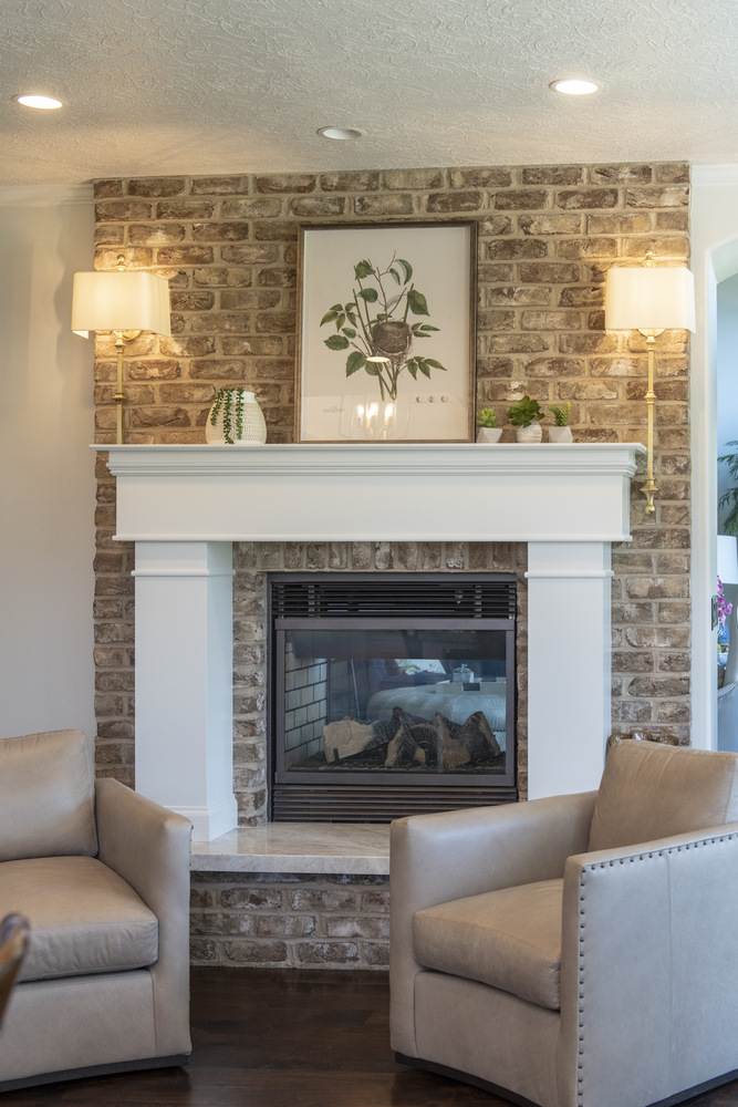 Warm living room corner with leather chairs and traditional fireplace by Conner Construction Company in Cedar Hills, UT