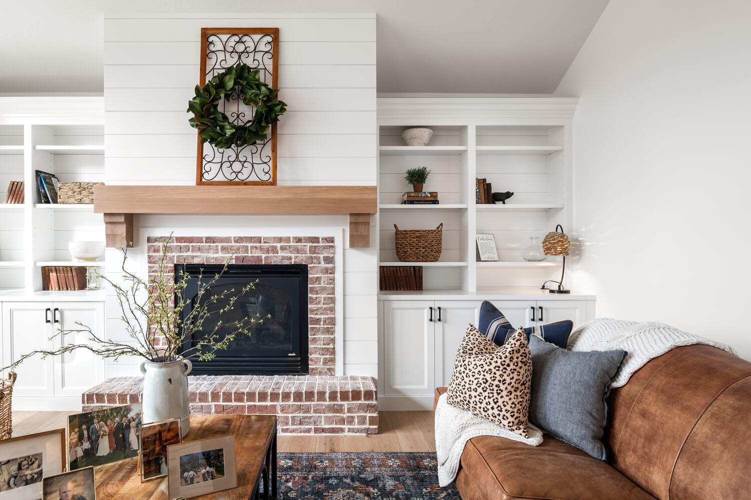Close-up of custom brick fireplace and built-in shelving in Highland, UT living room by Conner Construction Company