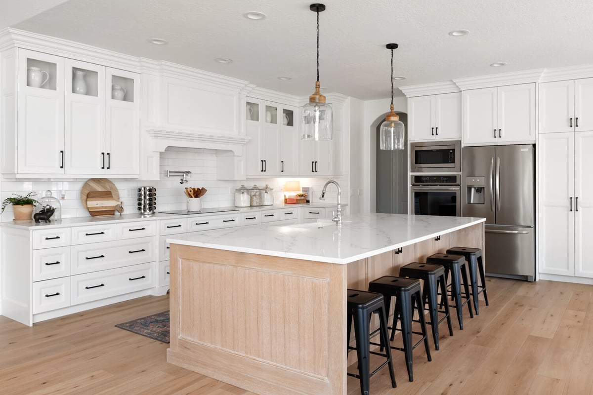 Spacious kitchen design with quartz countertops and bar seating in Highland, UT by Conner Construction Company