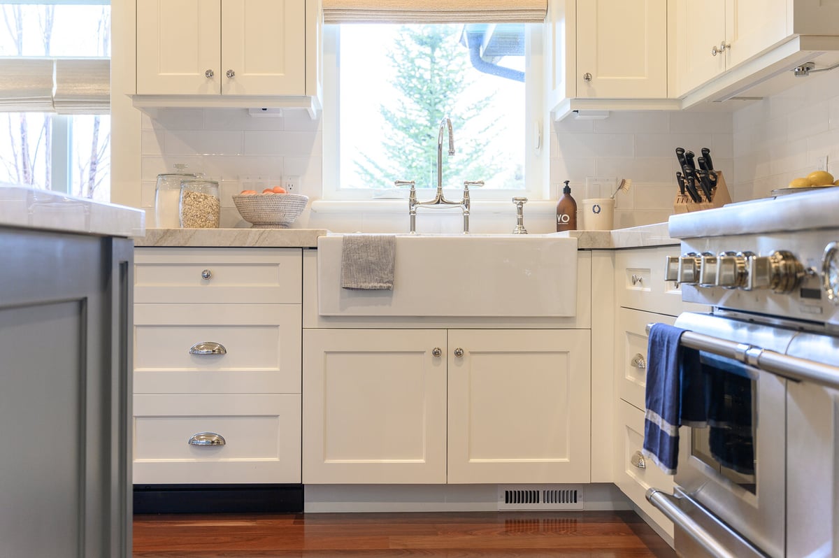Kitchen window view over apron sink with white cabinetry and marble countertops by Conner Construction Company in Provo, UT