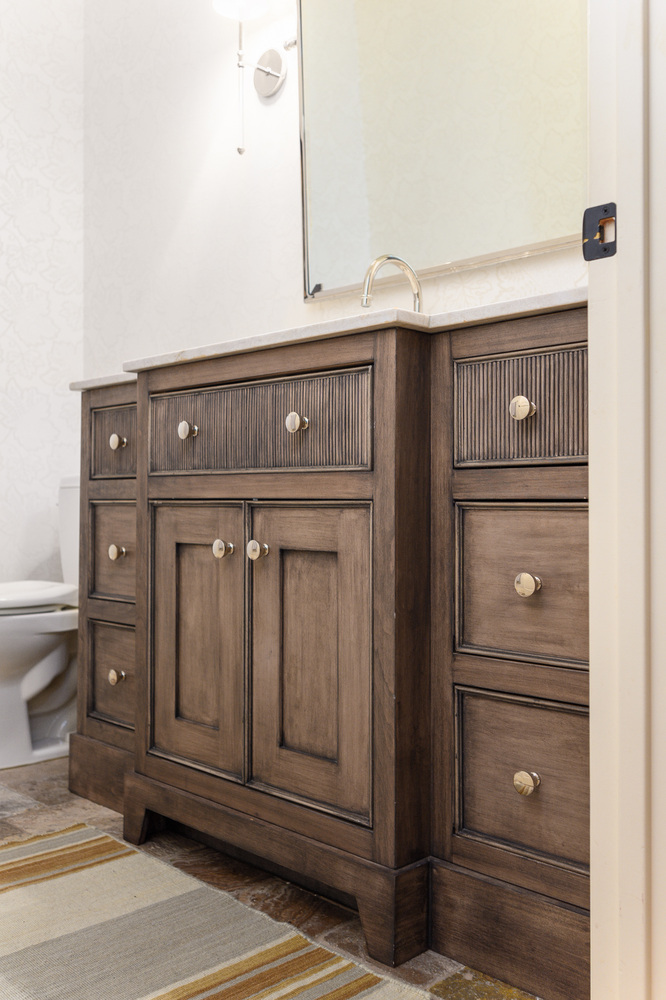 Rustic wood bathroom vanity with modern hardware in a custom home project by Conner Construction Company in Alpine, UT