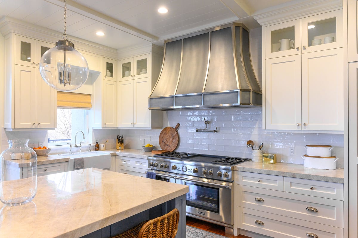 Stainless steel hood and professional gas range in a luxury kitchen remodel by Conner Construction Company in Park City, UT