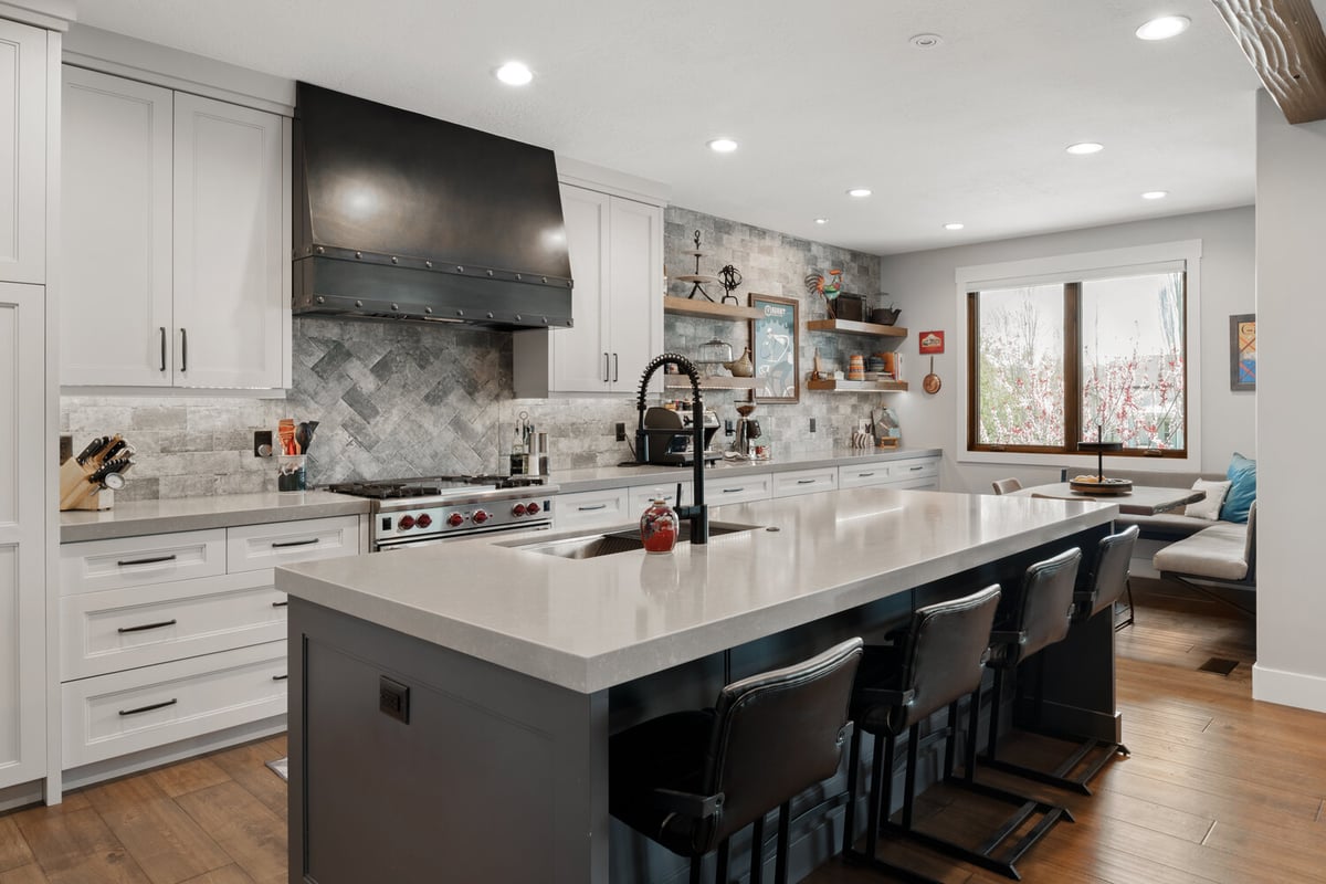 Bright kitchen remodel with mixed textures and industrial details by Conner Construction Company in Park City, UT