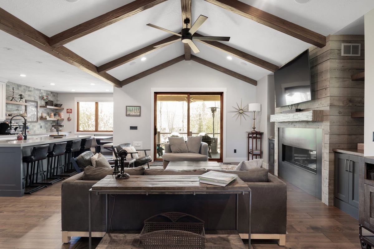 Custom home living space with wood ceiling accents and large glass doors by Conner Construction Company in Heber, UT