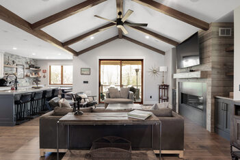 Custom home living space with wood ceiling accents and large glass doors by Conner Construction Company in Heber, UT