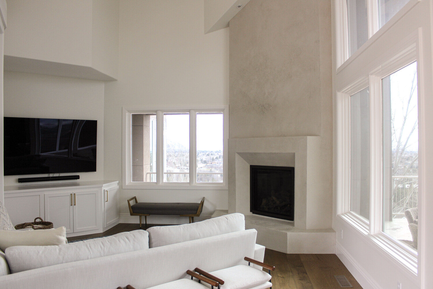 Corner fireplace and wall-mounted TV in vaulted ceiling living room by Conner Construction Company in Salt Lake County, UT