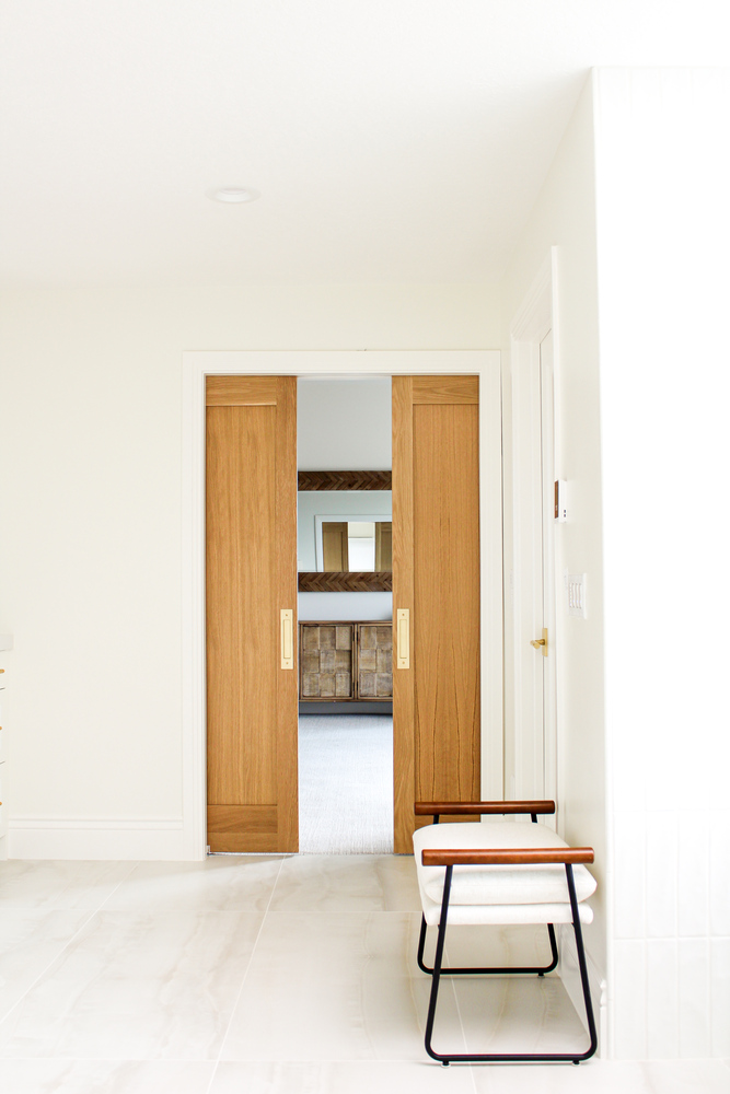 Custom wood sliding doors leading to bedroom in custom home by Conner Construction Company in Heber, UT