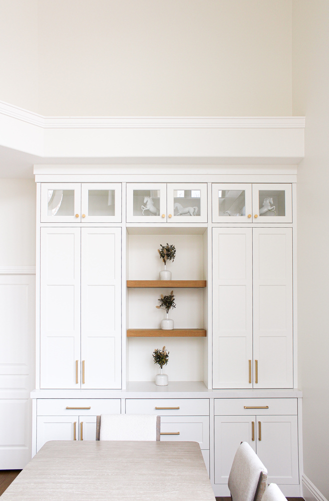 Dining room built-in featuring decorative vases and wood accents in a Draper, UT custom home by Conner Construction