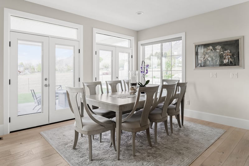 Dining room with natural light and large table in Pleasant Grove custom home by Conner Construction Company
