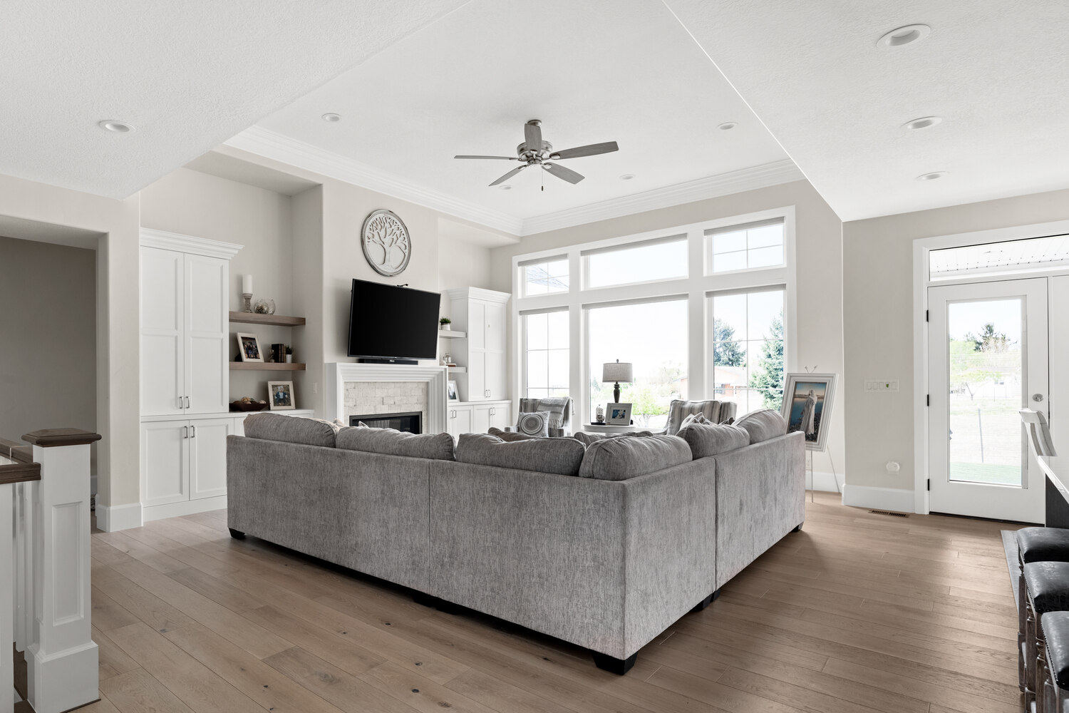 Living room with large sectional and fireplace in Pleasant Grove, UT custom home by Conner Construction Company