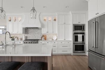 White shaker-style kitchen with stainless steel appliances in custom home by Conner Construction Company in Pleasant Grove, Utah.