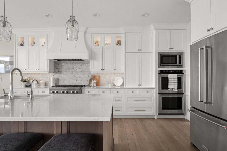 White shaker-style kitchen with stainless steel appliances in custom home by Conner Construction Company in Pleasant Grove, Utah