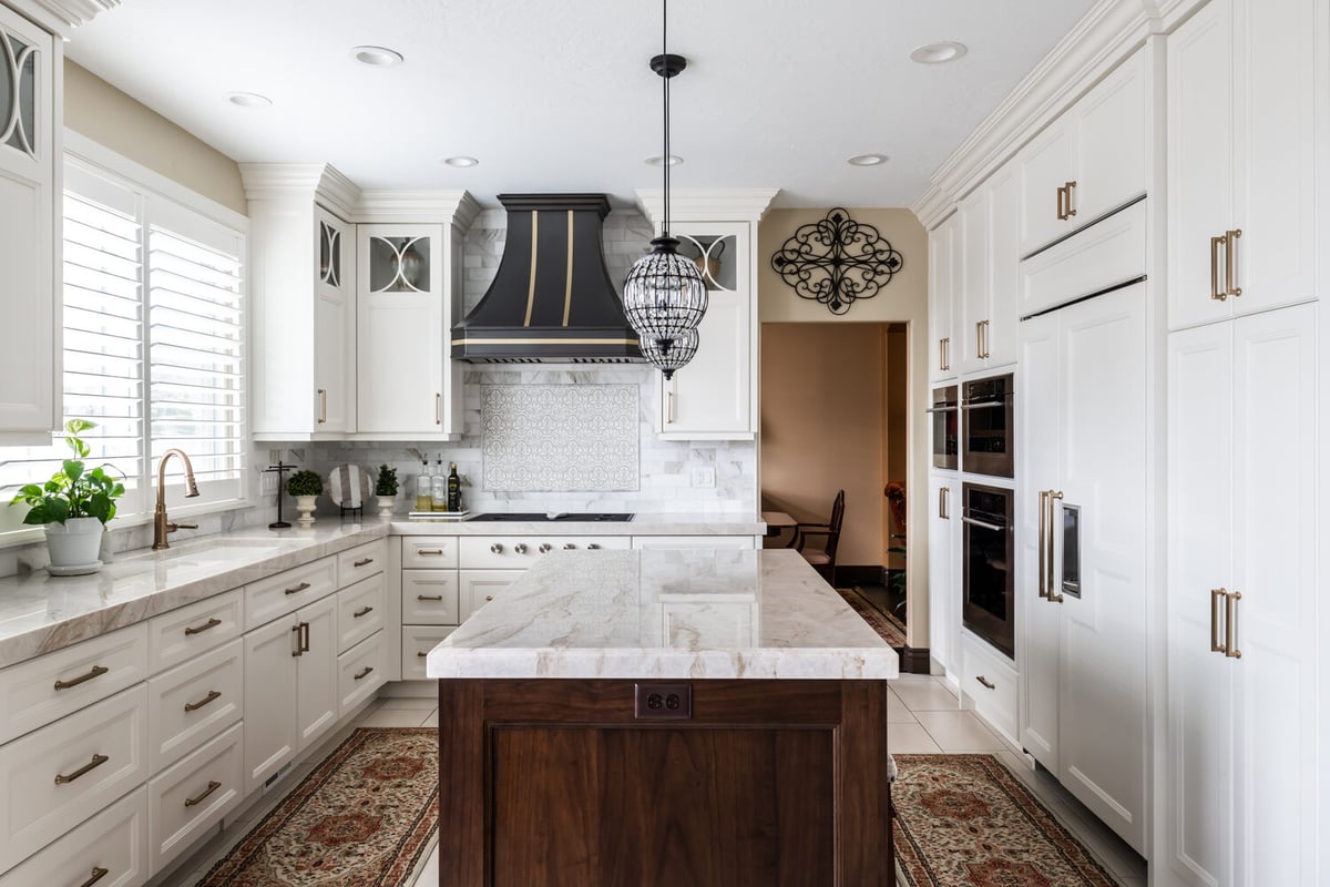 Highland, UT custom home kitchen by Conner Construction Company with white shaker cabinets and center island