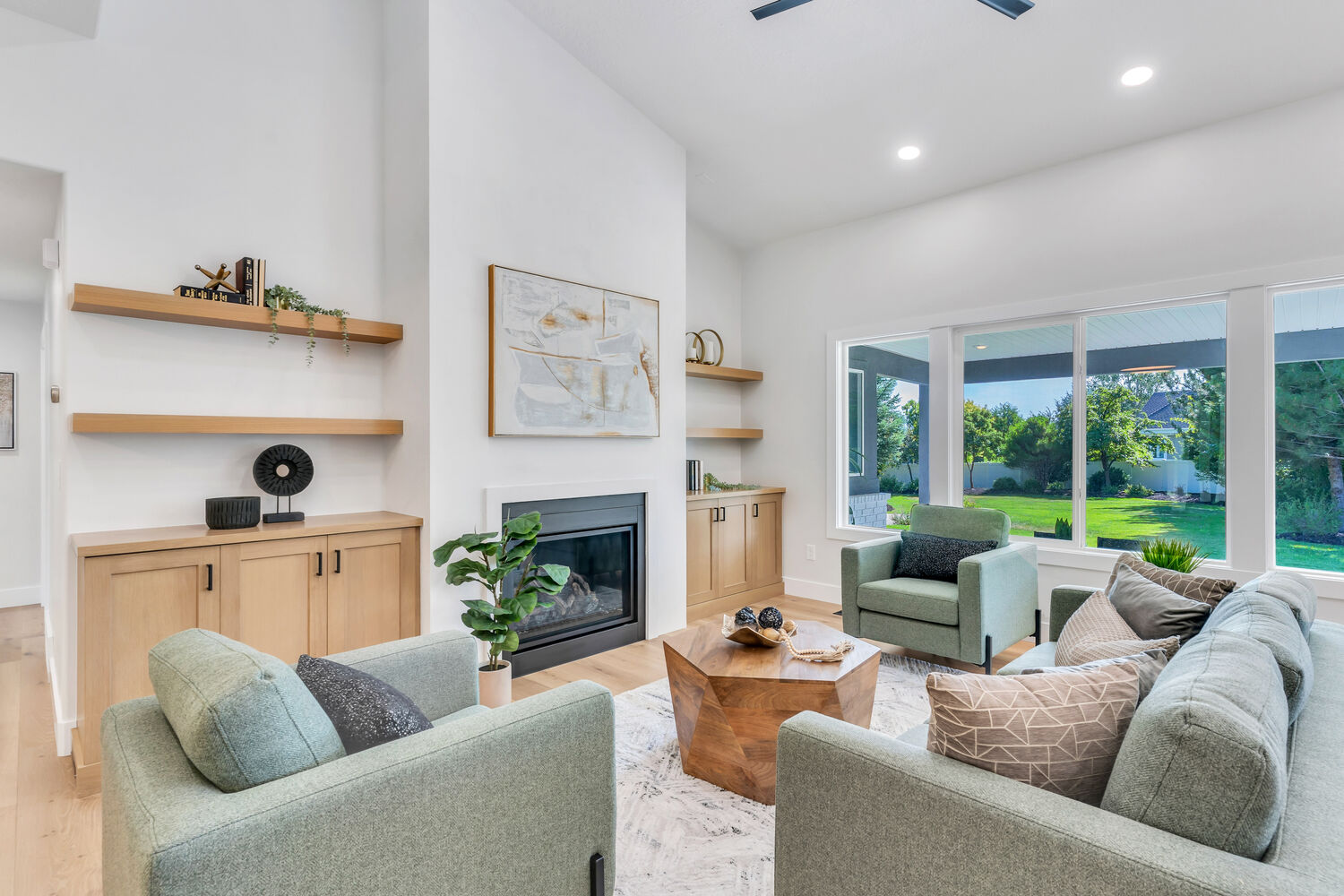 Modern living room with fireplace and large windows in a custom home by Conner Construction Company in Park City, UT