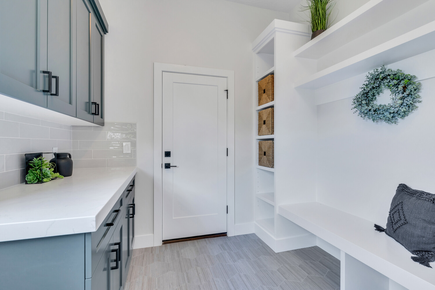 Organized entryway with built-in shelving and bench in a Conner Construction Company custom home in Kamas, UT