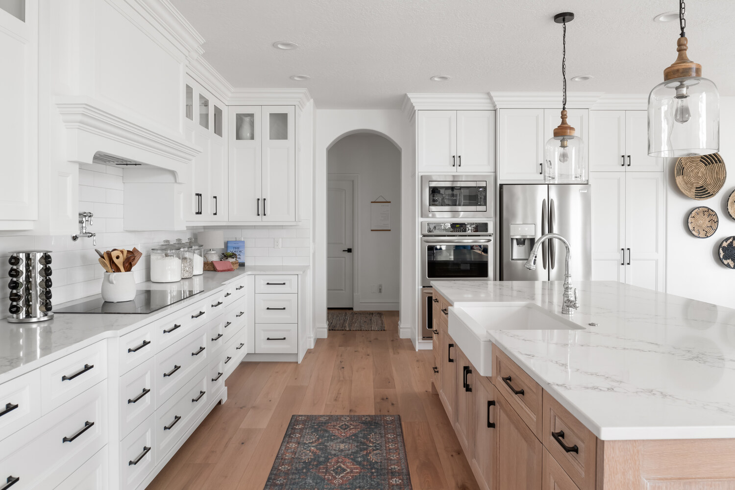 Open-concept kitchen view with shiplap fireplace in background in Highland, UT by Conner Construction Company