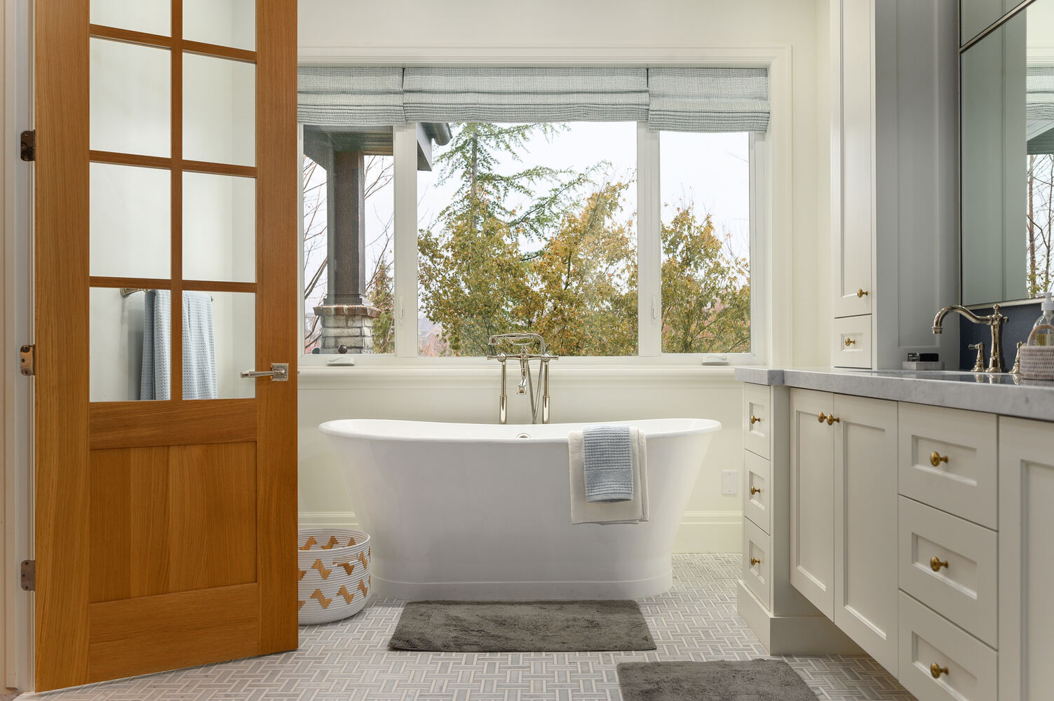 Luxurious primary bathroom in Highland, UT with freestanding tub and custom cabinetry by Conner Construction Company