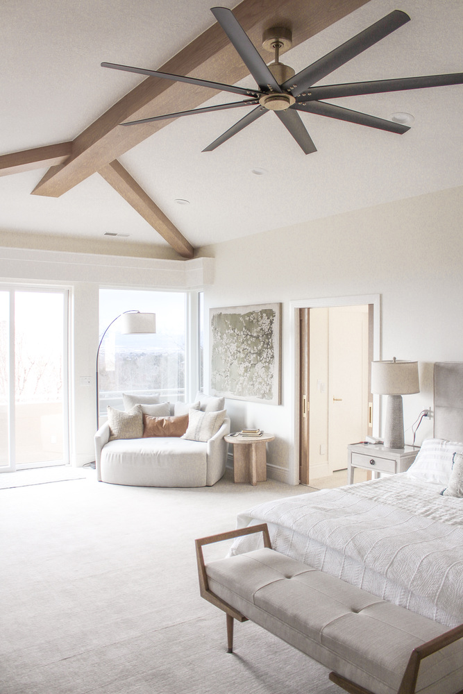 Vaulted ceiling primary bedroom with exposed beams and soft neutral tones by Conner Construction Company in Alpine, UT