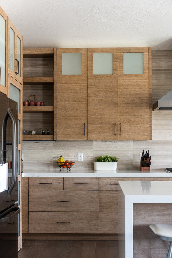Sleek wood cabinetry and quartz countertops in a Conner Construction custom home kitchen in American Fork, UT