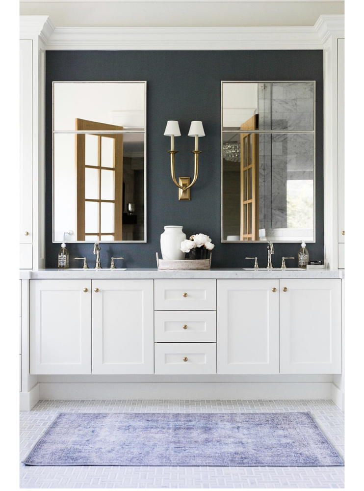 Custom bathroom vanity with gold sconces and double mirrors by Conner Construction Company in Park City, UT