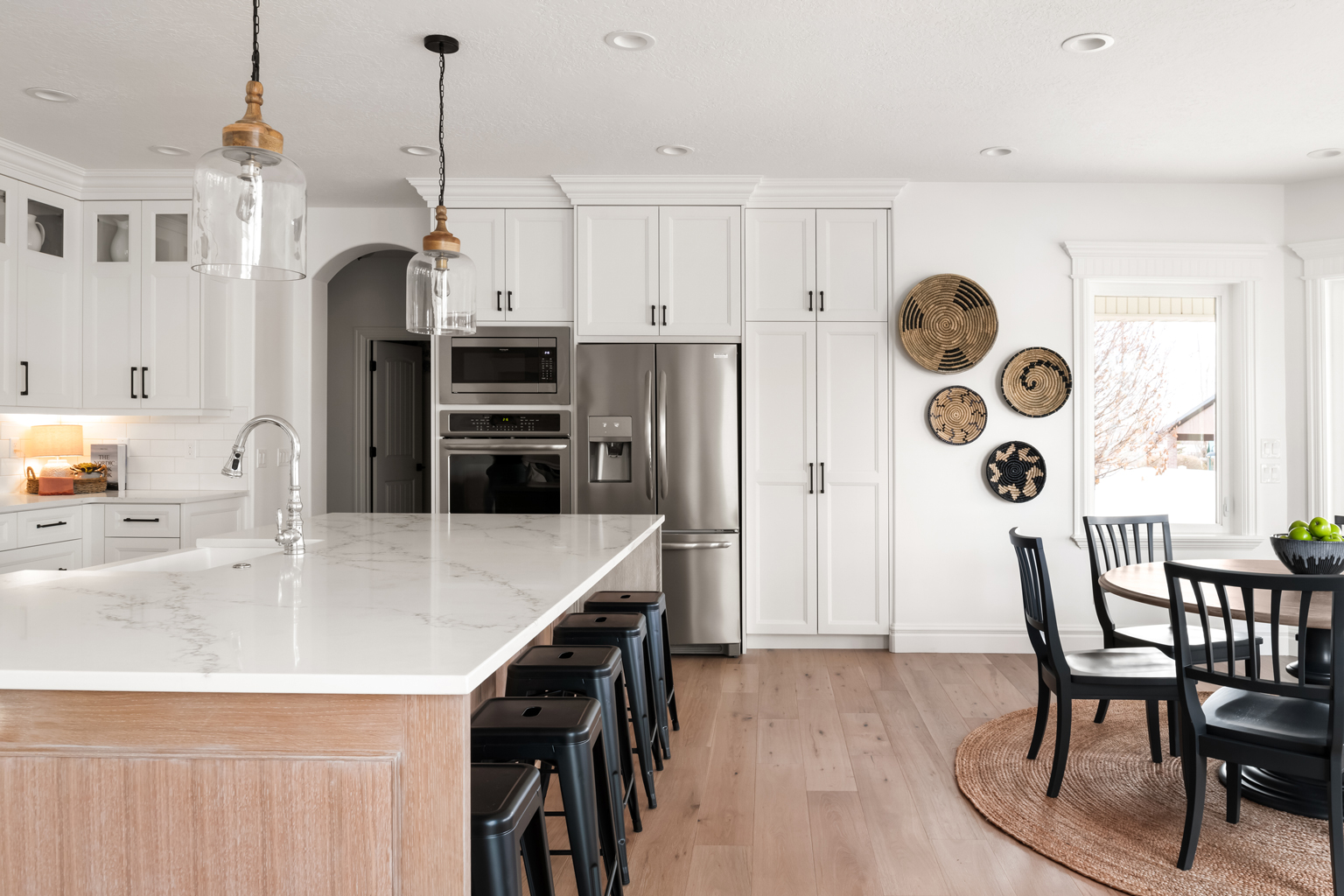 Utah Home Builders Kitchen featuring white cabinets and black chairs