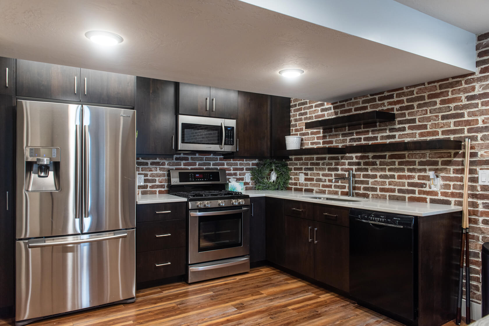 Utah Custom Home Builders Kitchens: A kitchen featuring brick walls and stainless steel appliances