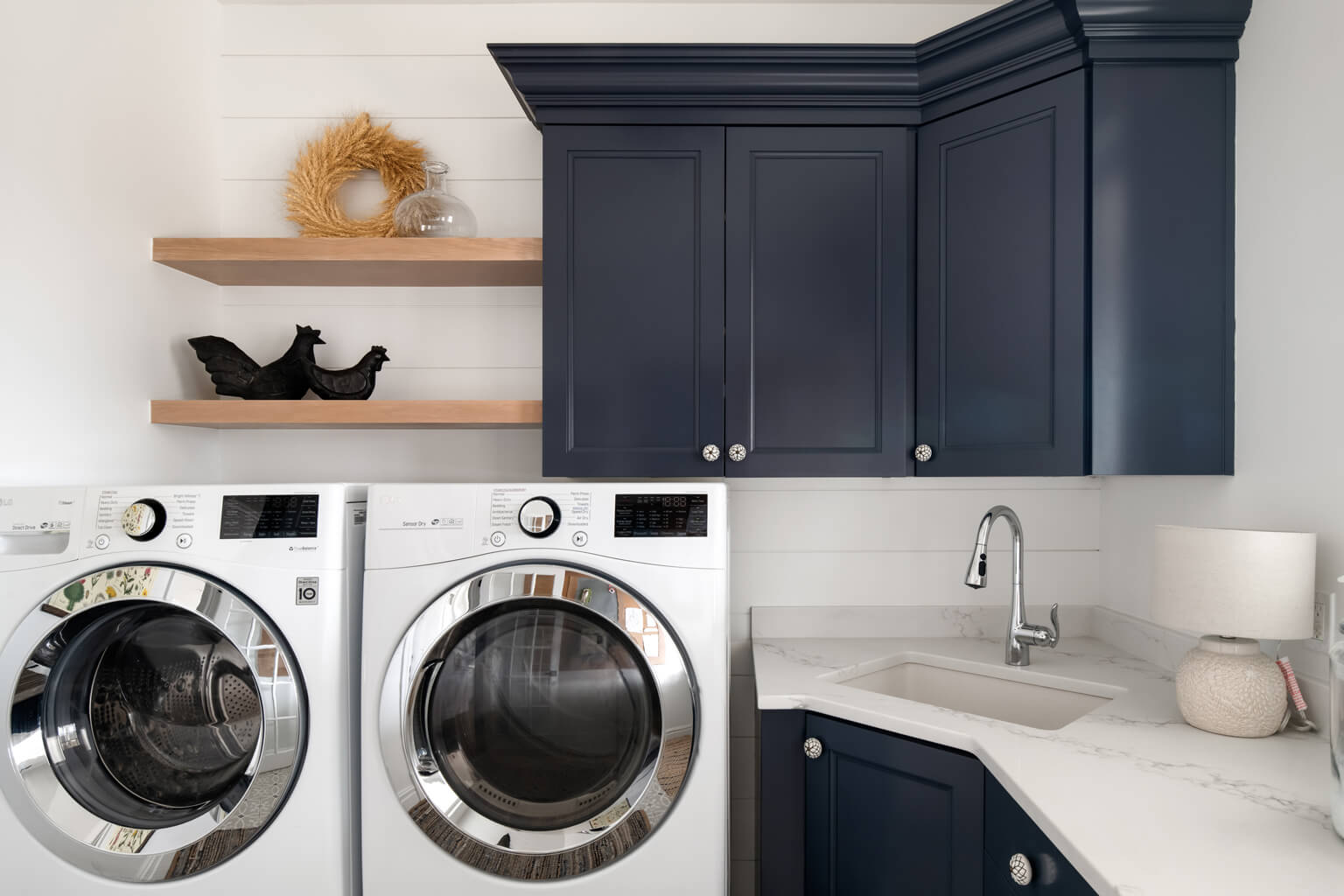 Utah Custom Home Builders Living Spaces showcase a tidy laundry room with a washer and dryer