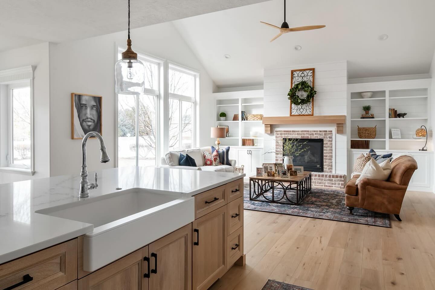 Utah Home Builders' kitchen featuring sink, stove, and fireplace