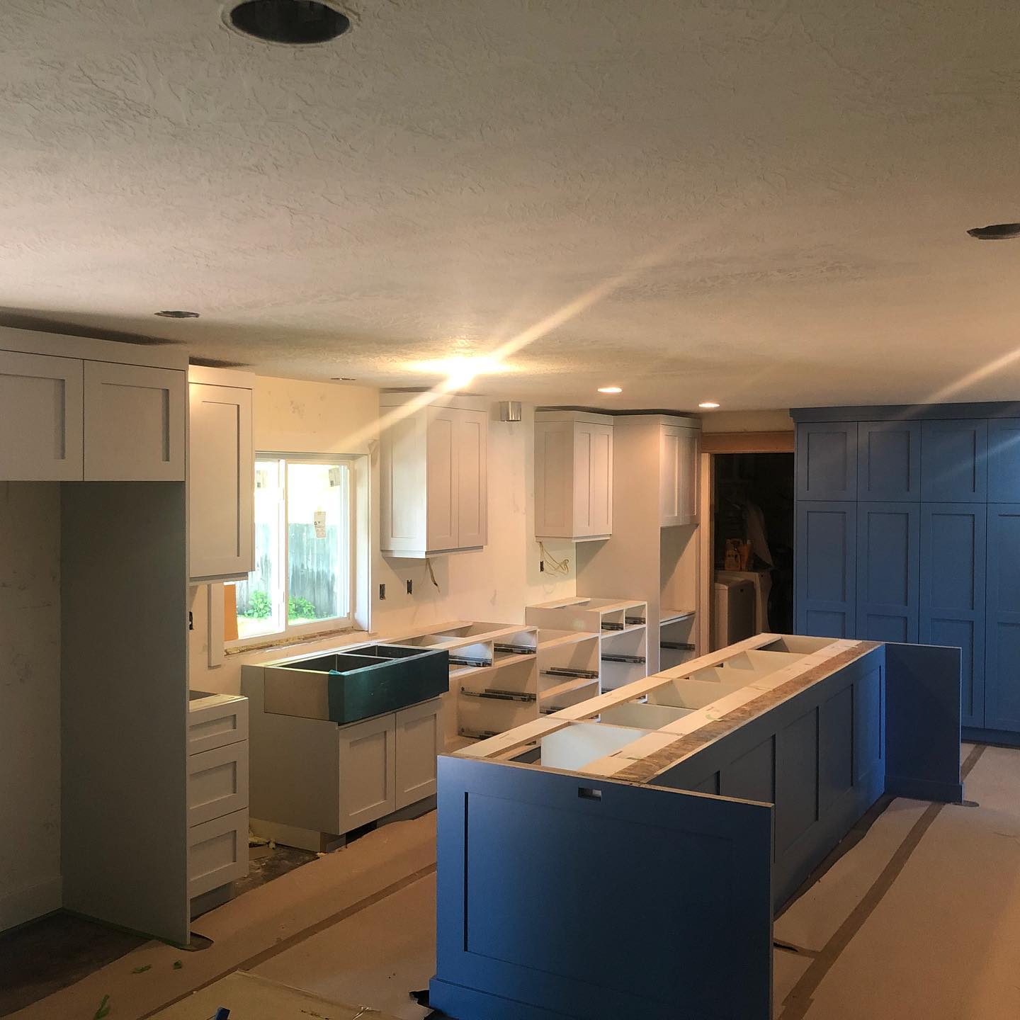 Blue cabinets and white countertops in a modern kitchen