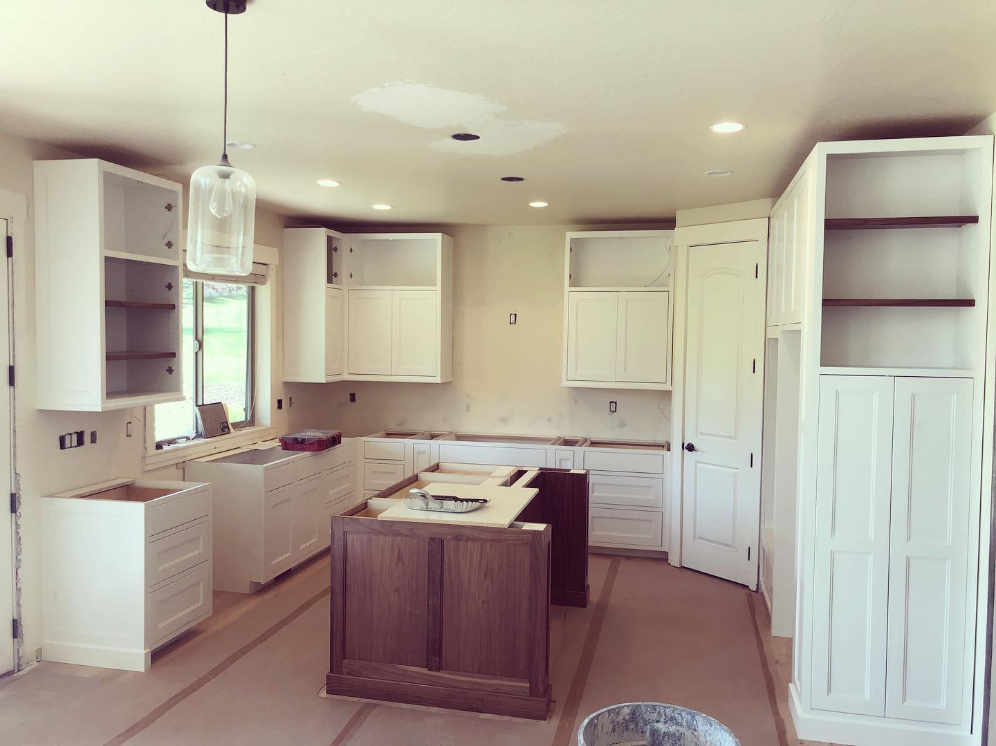 White kitchen cabinets and countertop in a modern kitchen setting