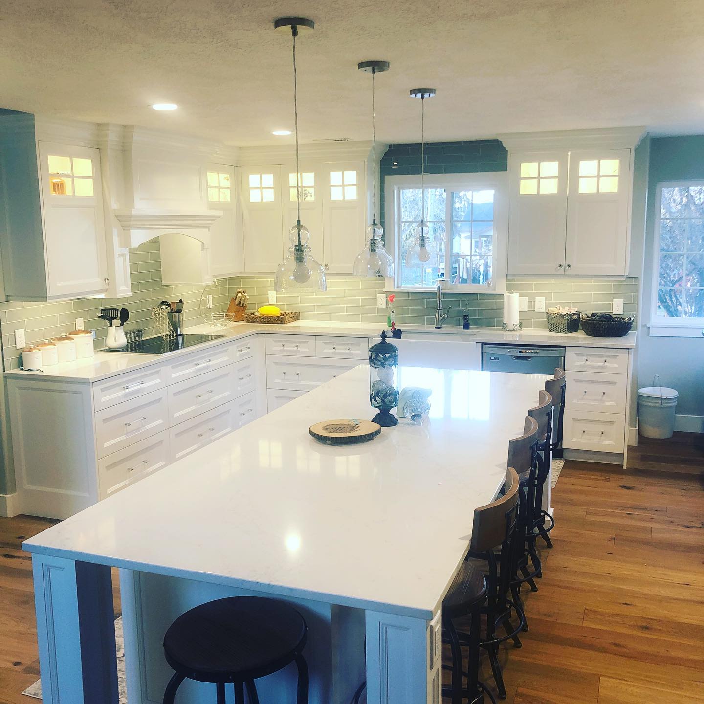 Kitchen with white cabinets and large island, perfect for cooking and entertaining guests.