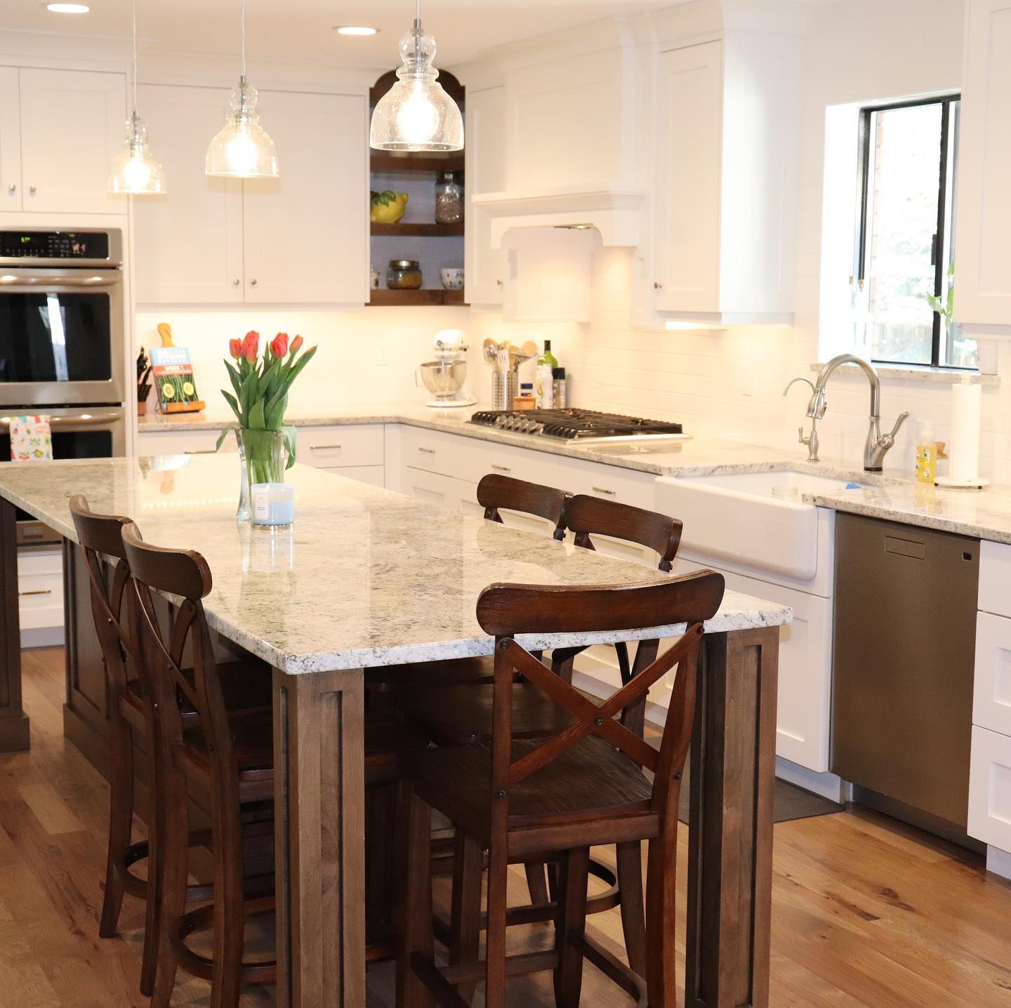 Kitchen with center island and wooden chairs, perfect for family gatherings and meal preparation